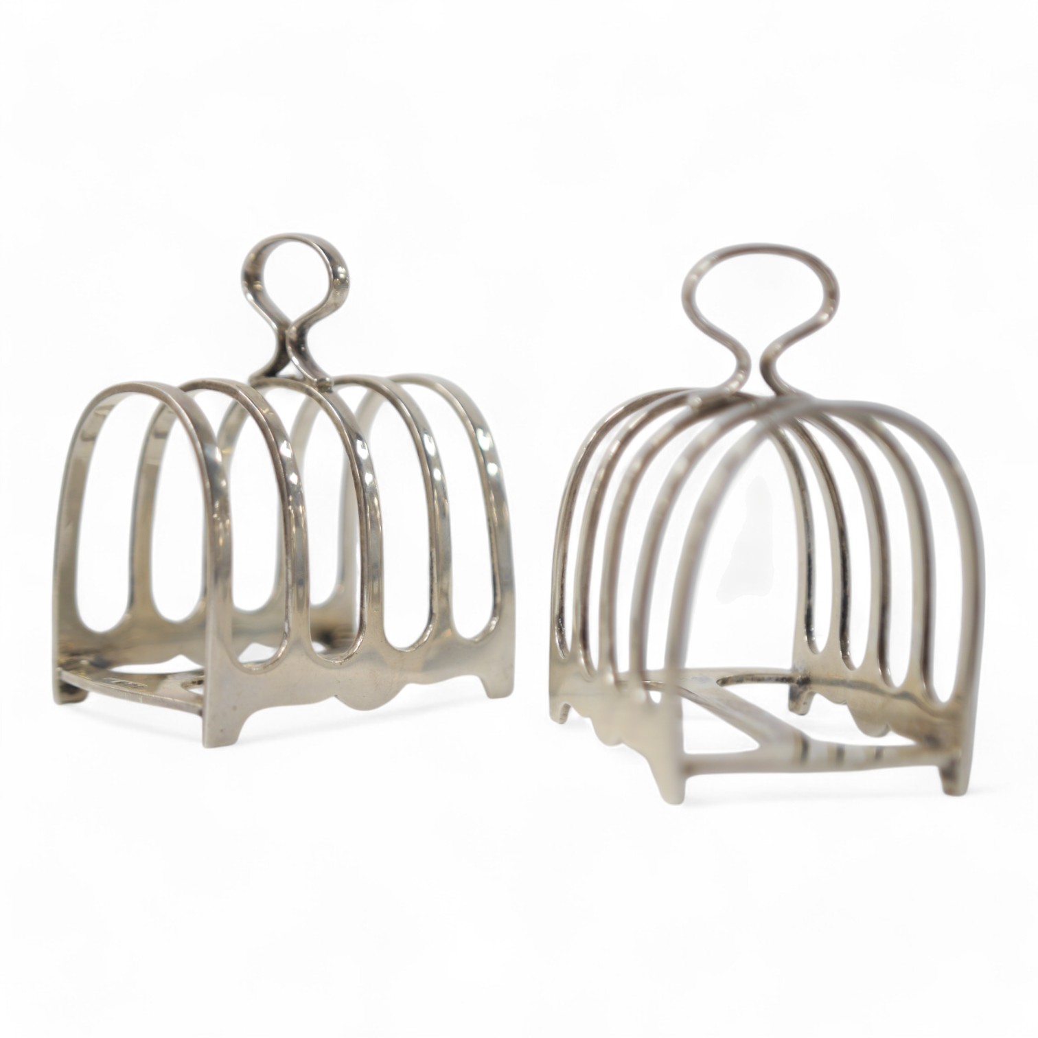 A pair of George V silver five bar toast racks, by Walker & Hall, Sheffield, 1933, length 79mm, 8.5oz. Condition - fair to good